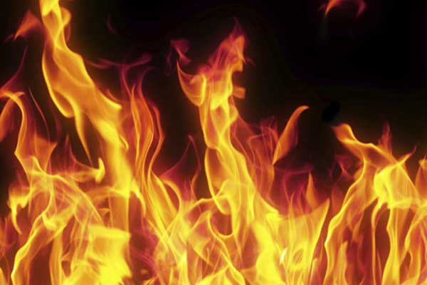 Woman dies as city building catches fire