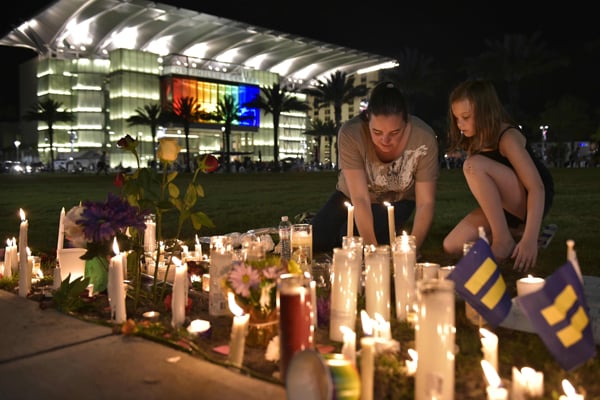Candles, tears and song for Orlando massacre victims