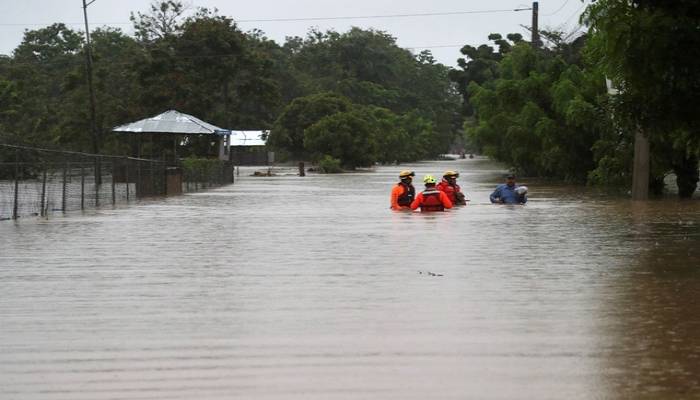 Thousands evacuate as duelling storms take aim