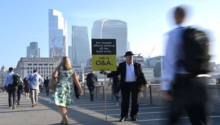 London's financial workers flock back to office in hot commuter crush