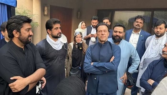 Imran Khan greets supporters after police withdraw