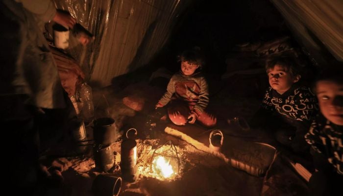 Freezing in makeshift tents, Gazans burn plastic to survive