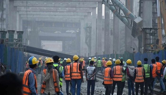 Crane from expressway falls on train track