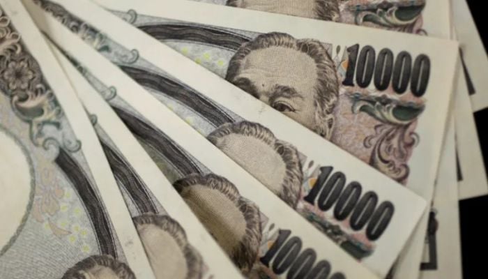 Japan’s yen plunges to lowest level against the dollar since 1990