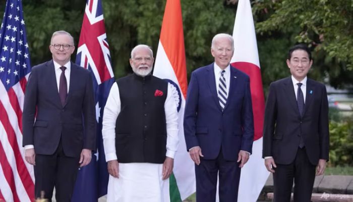 Biden says China 'testing us,' in hot mic remarks to Quad allies