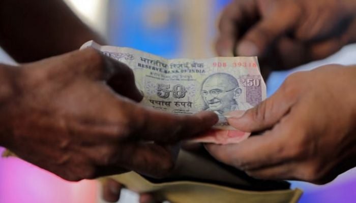 Rupee slips to record low