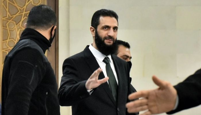Syria's new leader says all weapons to come under 'state control'