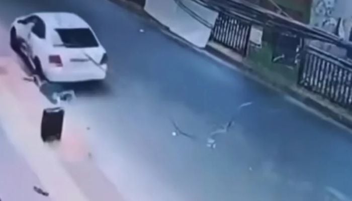 Muggers in moving car grabbed woman's bag and dragged her