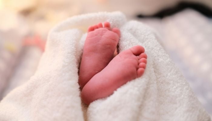Newborn baby buried alive in India fights for her life