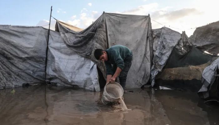 Palestinians suffer flooded tents and debris as cold and rain lash Gaza