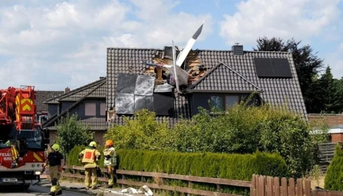 Two dead after plane crashes onto German house's roof